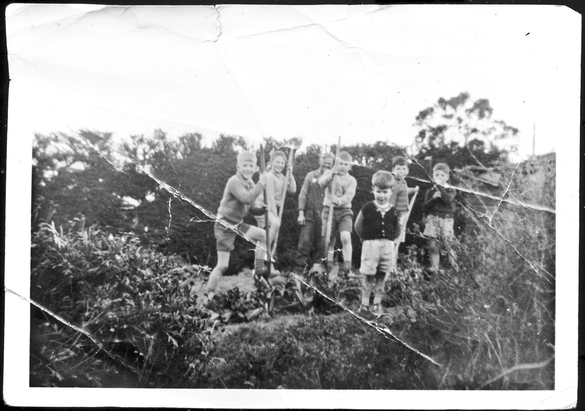 Harold Kindley with the kids digging in the garden at Burkes